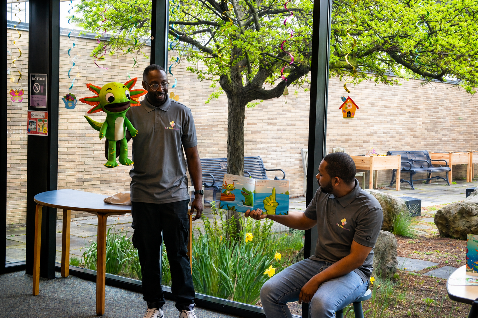 STEMtacular founders presenting with the Axl puppet during a community reading event
